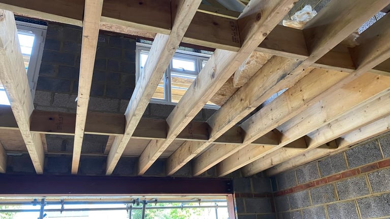 Wooden ceiling beams and joists in an under-construction building interior